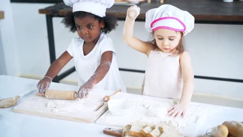 Diverse Group of Girls Prepare the Dough and Bake Cookies in the Kitchen