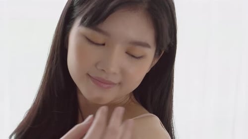 Young Woman Gently Touches Her Face