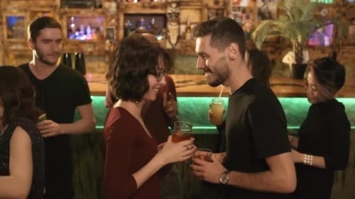 People Socializing and Drinking at Urban Bar at Night