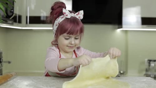 Cooking Pizza. Little Child in Apron Preparing Dough for Cooking at Home Kitchen