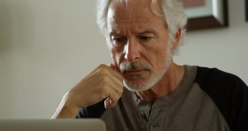 Senior Man with Laptop at Home