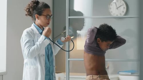 Doctor Examining Child Patient with Stethoscope