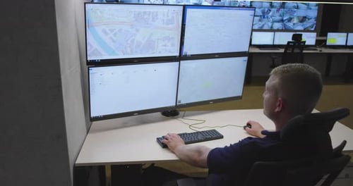 Security Guards Monitoring Modern CCTV Cameras in Surveillance Room
