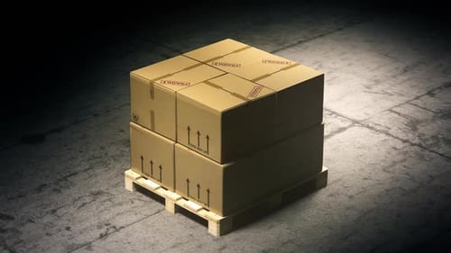 A stack of cardboard boxes on a pallet in the warehouse waiting for a forklift.