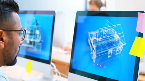 Architects Reviewing Blueprints on Computer Monitors in Office
