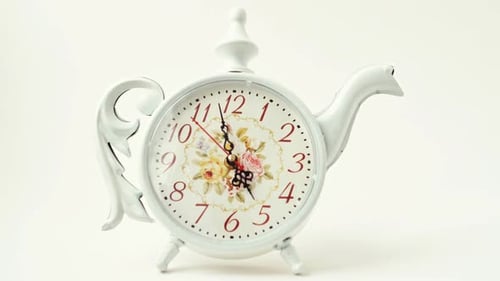 Teapot Clock with Floral Design on White Background