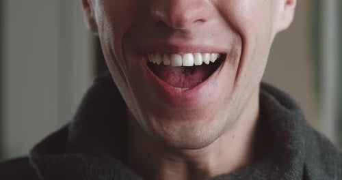 Smiling Man Reveals White Teeth in Close Up