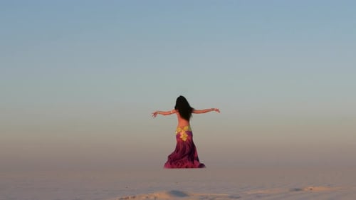 Woman Belly Dancing in Desert at Sunrise