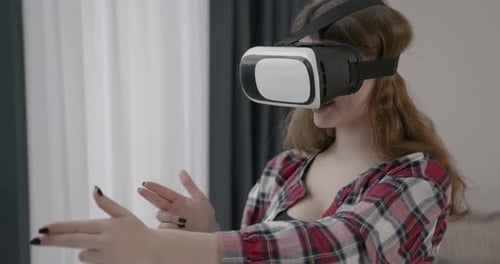 Young Girl in VR Glasses at Home
