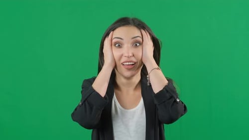 Portrait of Amazed Young Woman Over Green Screen Background for Keying. Shocked Woman with Mouth