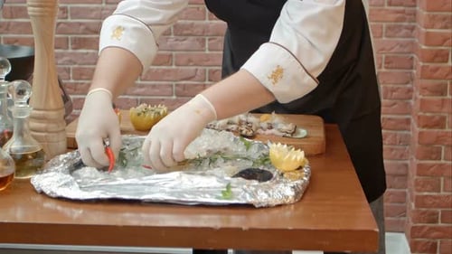 Chef Prepares Elegant Seafood Platter with Fresh Ingredients
