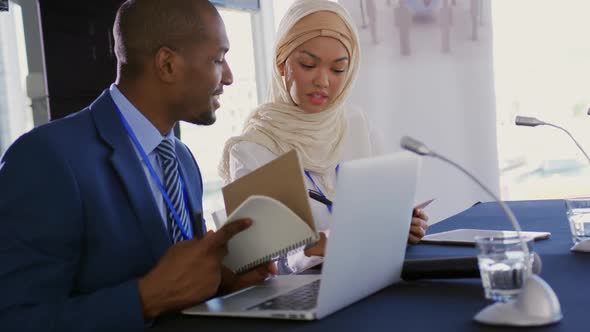 Two delegates talking making notes at a business conference, Business ...
