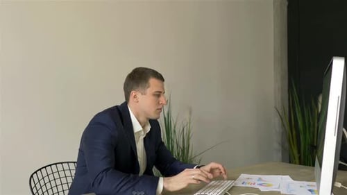 Young Adult Man Working At His Desk