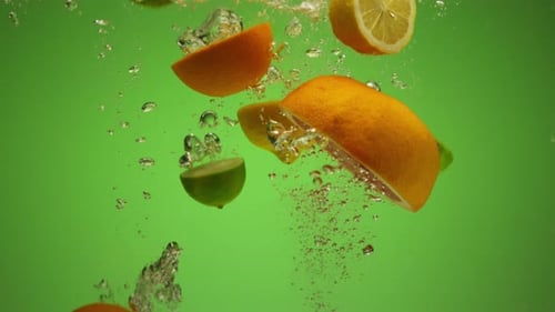 Mix of Exotic Citrus Fruits Falling Into Water in Slow Motion Orange Lime Grapefruit Lemon