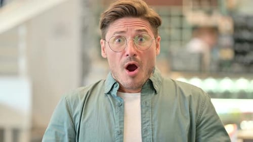 Adult Man Reacts in Shock and Surprise