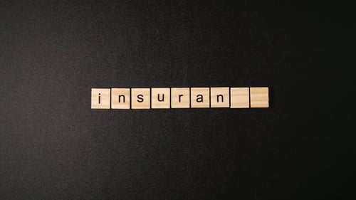 Insurance Spelled with Wooden Letter Tiles