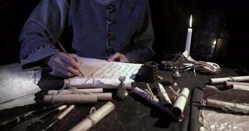 Person Writing Document by Candlelight