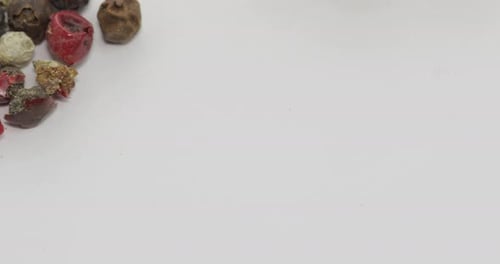 Colorful Peppercorns on White Surface