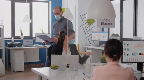 Office Workers Reviewing Documents During Pandemic