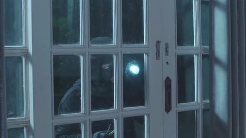 Burglar Picks Lock on Door with Flashlight