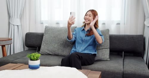 Young Woman Video Calling On Smartphone At Home