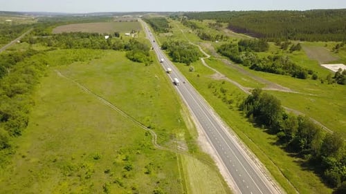 Aerial View of Highway with Trucks Driving By