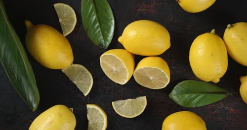 Overhead View of Fresh Lemons and Green Leaves