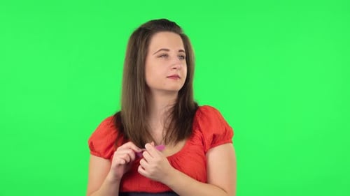 Portrait of Cute Girl Making Herself Manicure with Pink Nail File. Green Screen