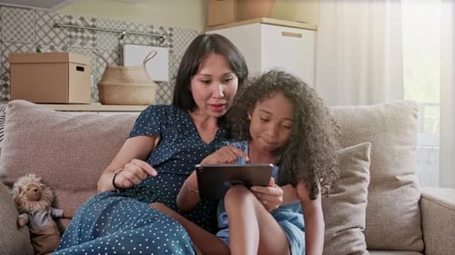 Mother and Child Enjoying Tablet Indoors