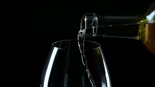 Pouring White Wine into Glass in Slow Motion