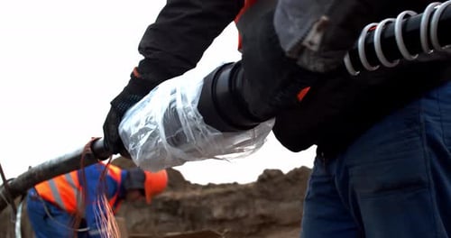 Workers Splicing Electrical Power Lines in Rural Setting