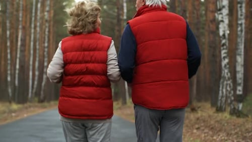 Aged Athletes Jogging in Woods