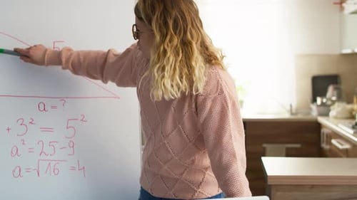 Woman Teaches Math with Whiteboard and Laptop