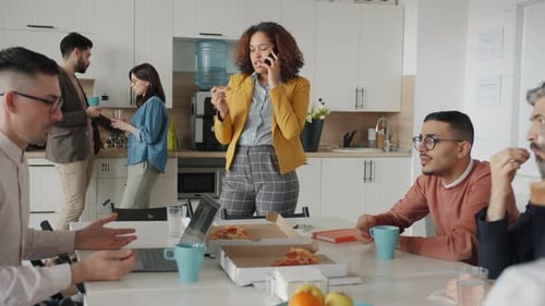 Office Workers Enjoying Pizza Lunch Together
