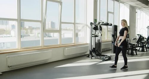 Young Active Athletic Blonde Girl Preparing for Work Out in the Gym