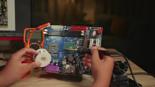 Close Up Hand's Boy Is Soldering Electronic Circuit And Works With Computer In Home