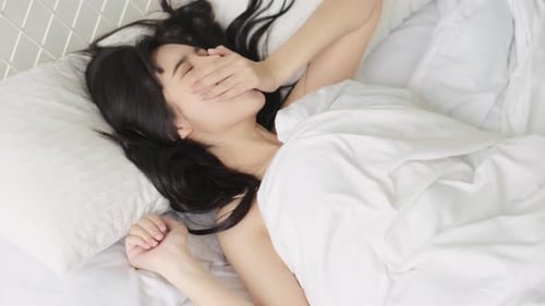 Woman Sleeping Peacefully in Bed at Home