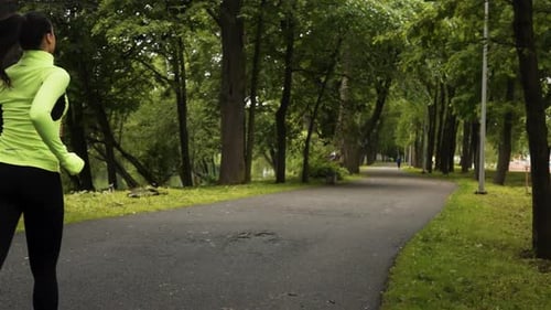 Runner Woman Running in Park Exercising Outdoors