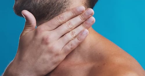 Close Up of Young Man Applying Healing Gel on His Neck