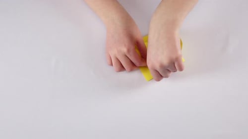 Yellow Fish Origami. White. Time Lapse