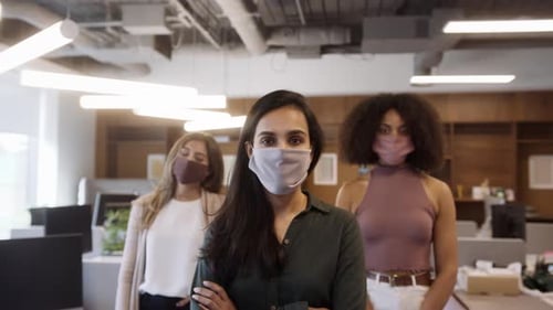 Portrait Of Female Business Team Wearing Face Masks In Open Plan Office During Covid-19 Pandemic