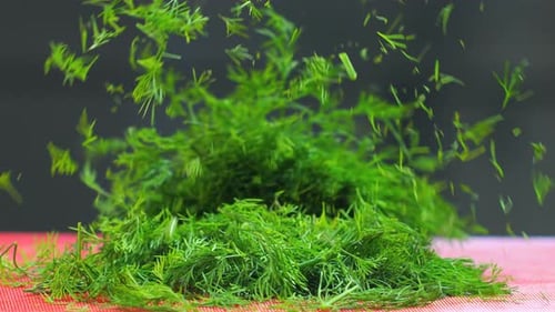Fresh Dill Being Chopped with Knife on Board