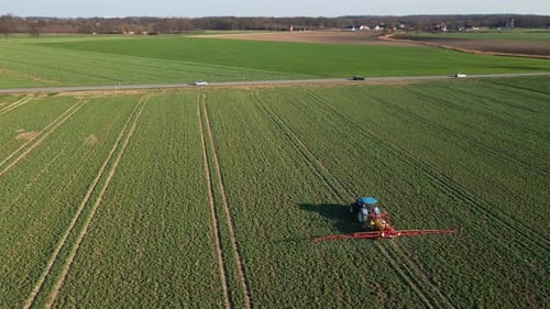 Tractor Spray Fertilizer on Agricultural Field Aerial View