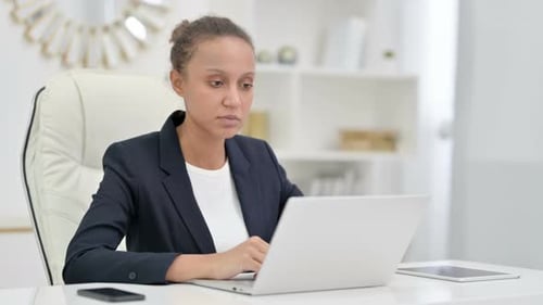 Professional African Businesswoman Doing Video Call on Laptop in Office