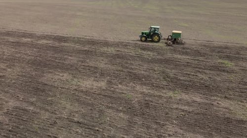 Tractor plows and cultivates the land for sowing in spring