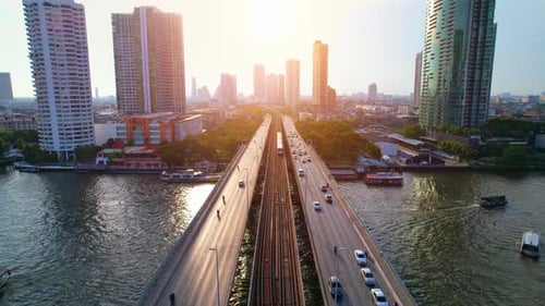 4K : Drones fly over the Chao Phraya River. Aerial view over bts skytrain