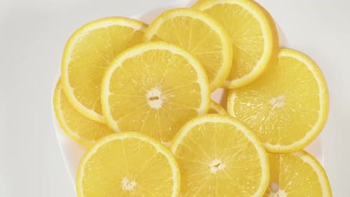 Bright Orange Slices on a White Plate