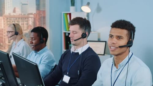 Diverse Call Center Employees Working at Computers