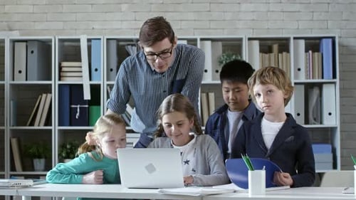 Students and Teacher Working Together in a Modern Office