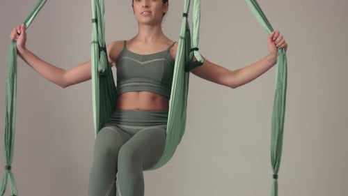 Woman Doing Aerial Yoga Hanging Upside Down